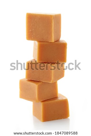 stack of caramel candies isolated on white background