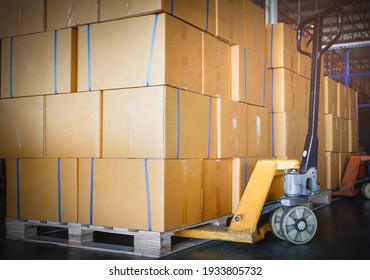 Stack of Card Board Boxes with Hand Pallet Truck. Interior of Storage Warehouse. Cargo Shipment Export- Import.  - Powered by Shutterstock