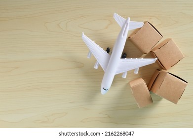 Stack of cardboard boxes and airplane with fast delivery of goods and products . Commodity trading