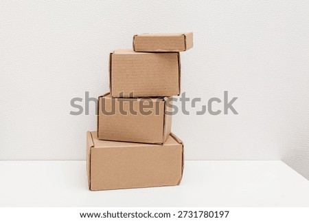 Stack of cardboard boxes of different sizes on white background. Self-assembled boxes