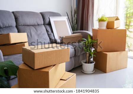 Stack of cardboard boxes in living room at new house on moving day