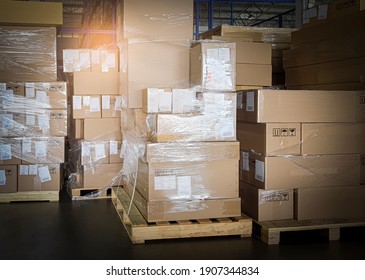 Stack of cardboard boxes on pallet rack in warehouse storage. Shipment. Cargo import and export. Industry manufacturing warehousing. - Shutterstock ID 1907344834