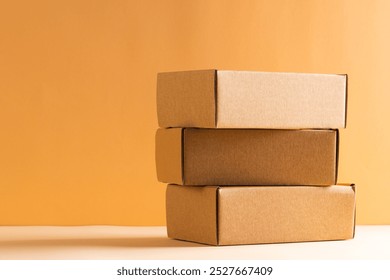 Stack of cardboard gift boxes with copy space over yellow background. Cyber monday, black friday, online shopping, shipping and global connections concept. - Powered by Shutterstock - Get 15% off with code: PIKWIZARD15