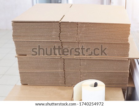 A stack of cardboard sheets for packing boxes in production. Pulp, waste paper, structure, carton