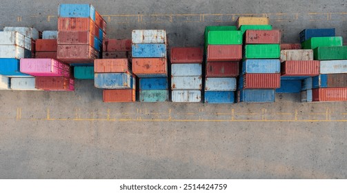 Stack of cargo containers in a terminal shipping yard, aerial top view.