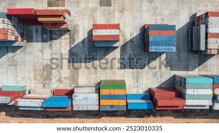 Stack of cargo containers in a terminal shipping yard, aerial top view.