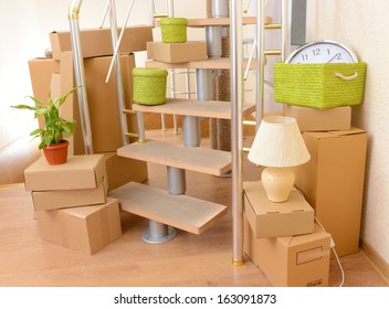 Stack Of Cartons Near Stairs: Moving House Concept 