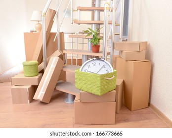 Stack Of Cartons Near Stairs: Moving House Concept 