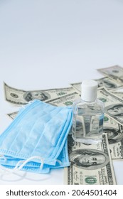 Stack of cash dollars and medical mask sanitizer antiseptic. The concept of medical expensive medicine. Copy space for text. Health Life insurance. vaccination costs. Covid-19 crimes. Financial crisis - Shutterstock ID 2064501404