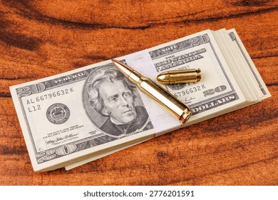 A stack of cash with two bullets on a mahogany table illustrates the danger of illegal deals and the violent nature of the criminal underworld today.