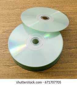 Stack of CD or DVD Compact Disc on A Wooden Table.
