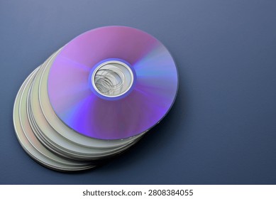 stack of CDs against a blue background