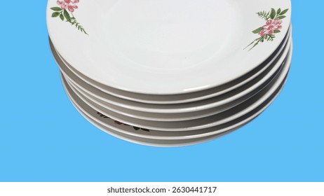 stack of ceramic plates on blue background, front view close up