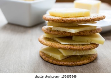 A Stack Of Cheese And Crackers Piled High.