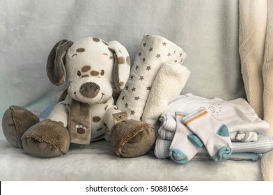 A Stack Of Children's Clothing, Toys, Pacifier On A White Background. Preparing For Motherhood. Shopping For Baby.