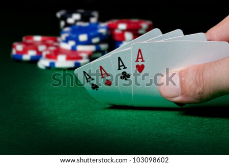 Stack of chips and four aces