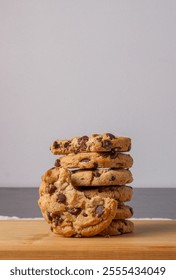 Stack of chocolate chip cookies on wooden board