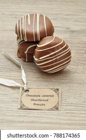 A Stack Of Chocolate Covered Shortbread Biscuits With A Name Tag 