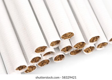Stack of cigarettes close-up on white background.