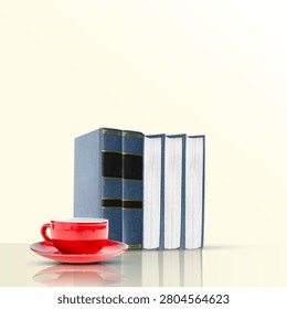 Stack of classic blue books standing upright next to a vibrant red coffee cup and saucer, set on a reflective surface with a clean minimalist background