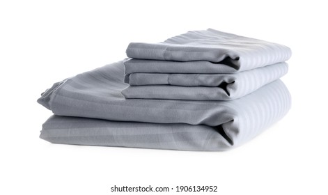 Stack of clean bed sheets isolated on white