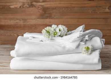 Stack Of Clean Bed Sheets On Table