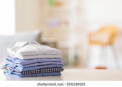Stack Of Clean Clothes On Table In Room