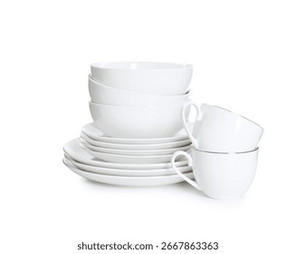 Stack of clean dishware and cups isolated on white