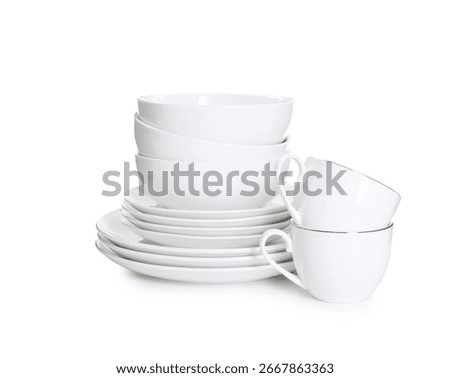Stack of clean dishware and cups isolated on white