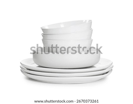 Stack of clean dishware isolated on white