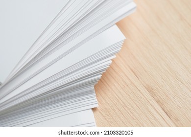 Stack of clean sheets paper, laid out randomly in wooden background. Abstract background of paper sheets - Shutterstock ID 2103320105