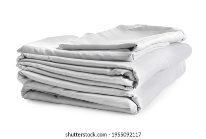 Stack of clean silky bed linen isolated on white