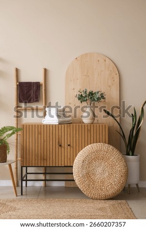 Stack of clean soft towels on wooden cabinet at home