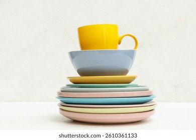 Stack of clean tableware on white background
