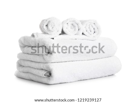 Stack of clean towels on white background
