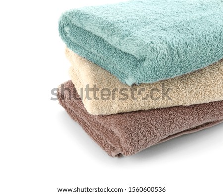 Stack of clean towels on white background