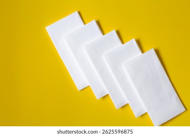 A stack of clean, white dry tissues arranged neatly on a surface. Soft texture and hygienic appearance, ideal for personal care, hygiene, or household use. Minimalist background emphasizes cleanlines