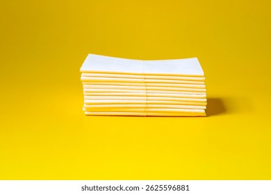 A stack of clean, white dry tissues arranged neatly on a surface. Soft texture and hygienic appearance, ideal for personal care, hygiene, or household use. Minimalist background emphasizes cleanlines