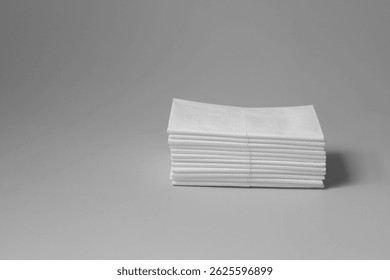 A stack of clean, white dry tissues arranged neatly on a surface. Soft texture and hygienic appearance, ideal for personal care, hygiene, or household use. Minimalist background emphasizes cleanlines