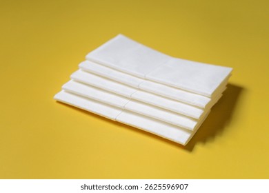 A stack of clean, white dry tissues arranged neatly on a surface. Soft texture and hygienic appearance, ideal for personal care, hygiene, or household use. Minimalist background emphasizes cleanlines