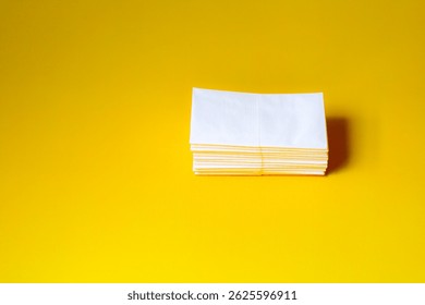 A stack of clean, white dry tissues arranged neatly on a surface. Soft texture and hygienic appearance, ideal for personal care, hygiene, or household use. Minimalist background emphasizes cleanlines