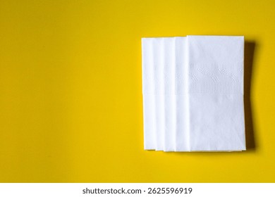 A stack of clean, white dry tissues arranged neatly on a surface. Soft texture and hygienic appearance, ideal for personal care, hygiene, or household use. Minimalist background emphasizes cleanlines