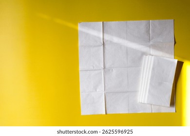 A stack of clean, white dry tissues arranged neatly on a surface. Soft texture and hygienic appearance, ideal for personal care, hygiene, or household use. Minimalist background emphasizes cleanlines