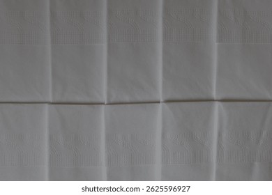 A stack of clean, white dry tissues arranged neatly on a surface. Soft texture and hygienic appearance, ideal for personal care, hygiene, or household use. Minimalist background emphasizes cleanlines