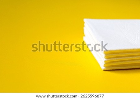 A stack of clean, white dry tissues arranged neatly on a surface. Soft texture and hygienic appearance, ideal for personal care, hygiene, or household use. Minimalist background emphasizes cleanlines