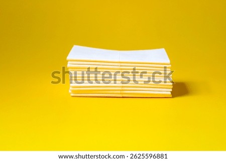 A stack of clean, white dry tissues arranged neatly on a surface. Soft texture and hygienic appearance, ideal for personal care, hygiene, or household use. Minimalist background emphasizes cleanlines