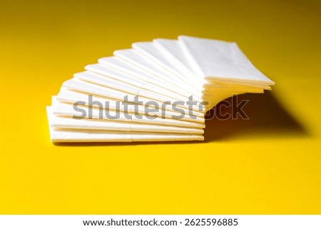 A stack of clean, white dry tissues arranged neatly on a surface. Soft texture and hygienic appearance, ideal for personal care, hygiene, or household use. Minimalist background emphasizes cleanlines