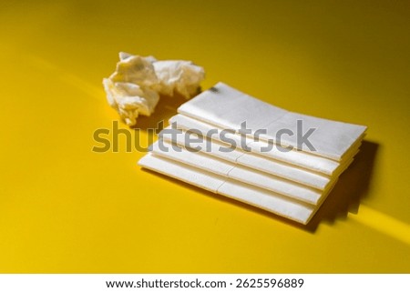 A stack of clean, white dry tissues arranged neatly on a surface. Soft texture and hygienic appearance, ideal for personal care, hygiene, or household use. Minimalist background emphasizes cleanlines