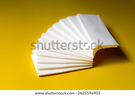 A stack of clean, white dry tissues arranged neatly on a surface. Soft texture and hygienic appearance, ideal for personal care, hygiene, or household use. Minimalist background emphasizes cleanlines