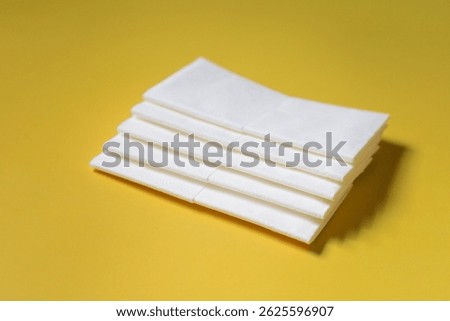 A stack of clean, white dry tissues arranged neatly on a surface. Soft texture and hygienic appearance, ideal for personal care, hygiene, or household use. Minimalist background emphasizes cleanlines